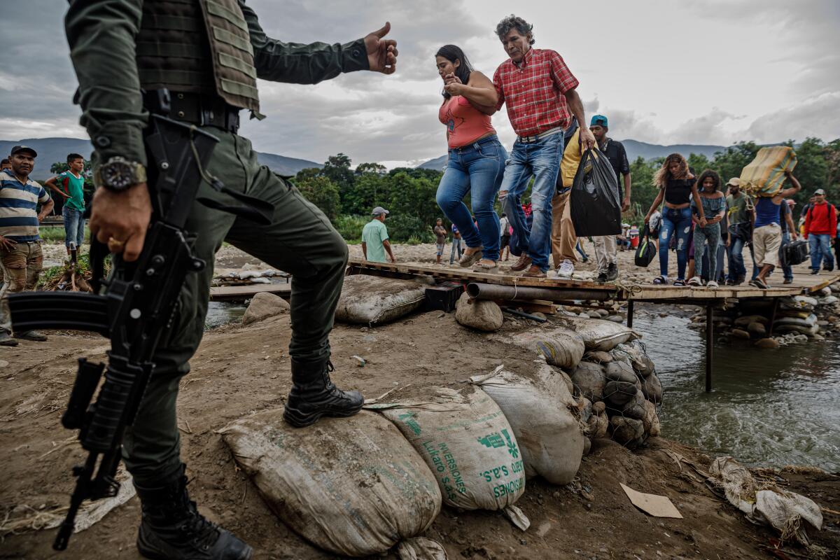 Venezuelans cross the Colombia-Venezuela border.