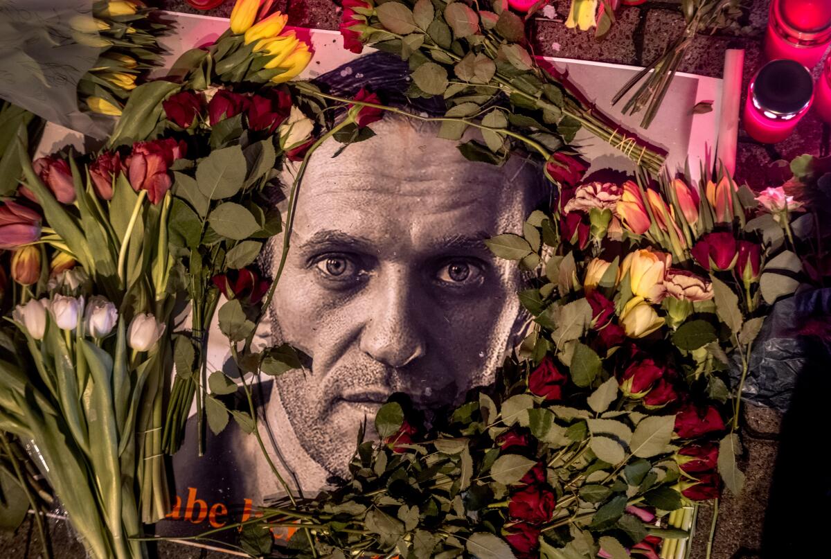 Flowers and a photo of Alexei Navalny are placed near the Russian Consulate in Frankfurt, Germany.