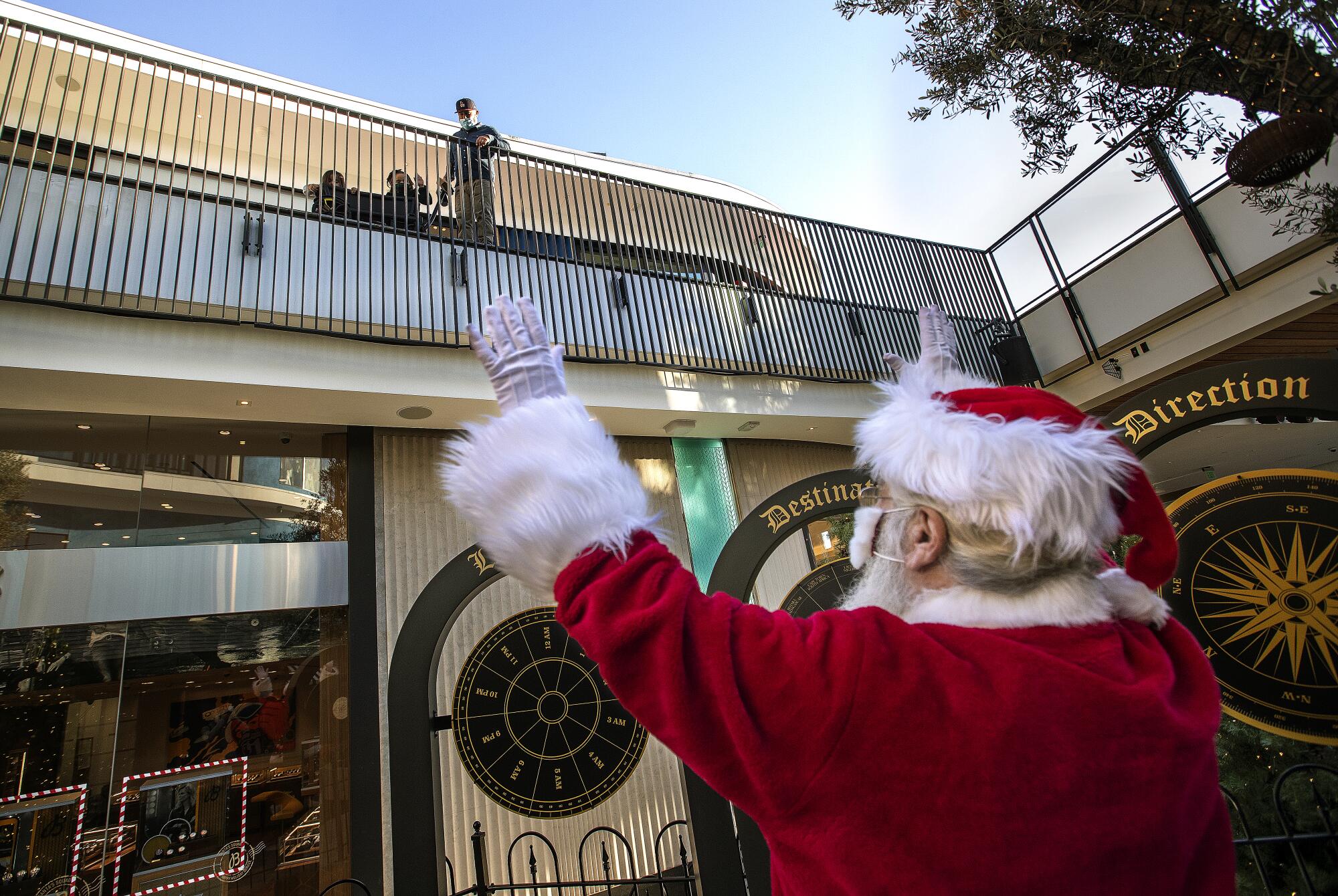 Larry Buckelew, dressed up as Santa Claus, greets visitors to the Westfield Century City shopping mall.