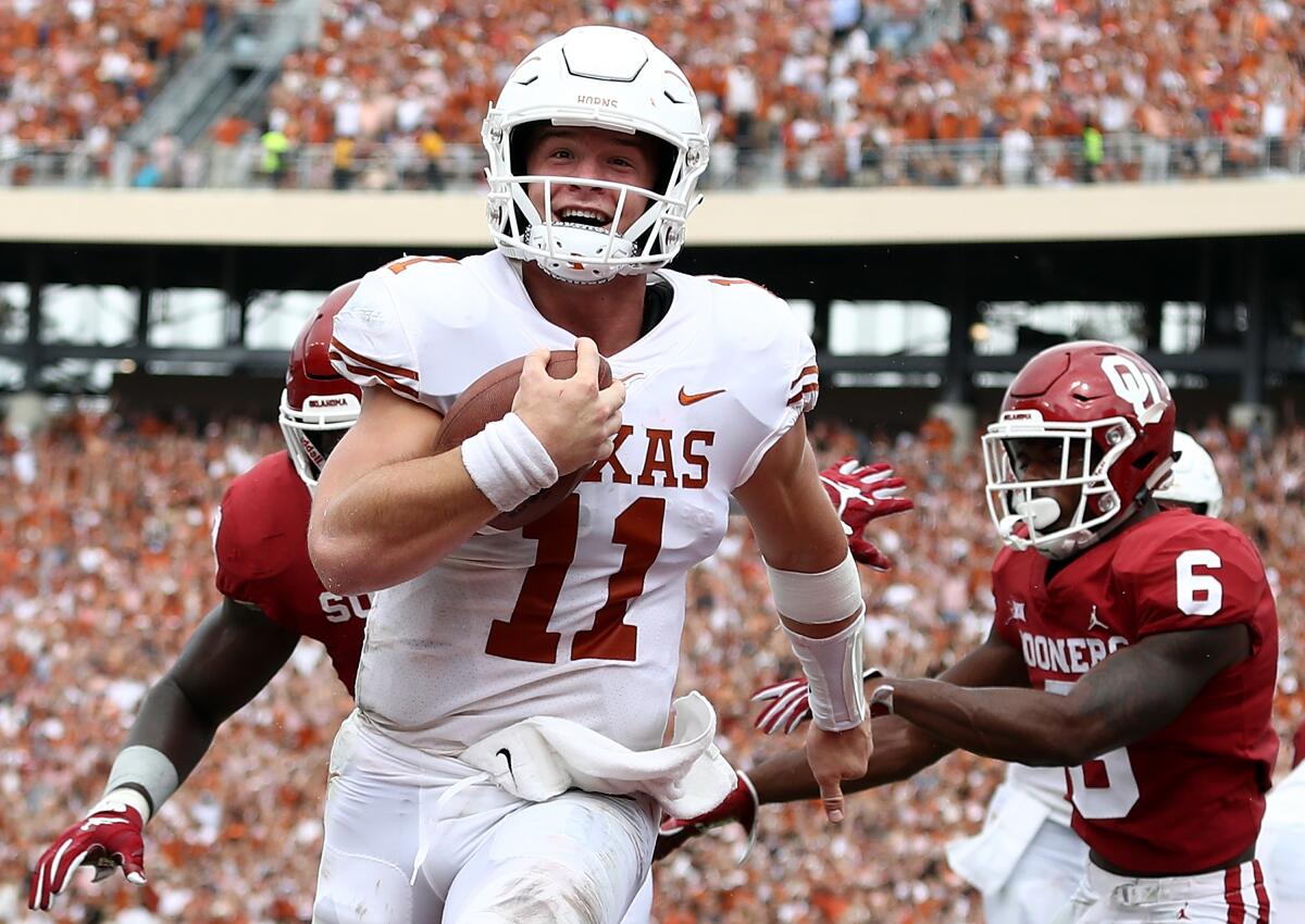 Texas quarterback Sam Ehlinger scores a touchdown against the Oklahoma Sooners in October 2018.