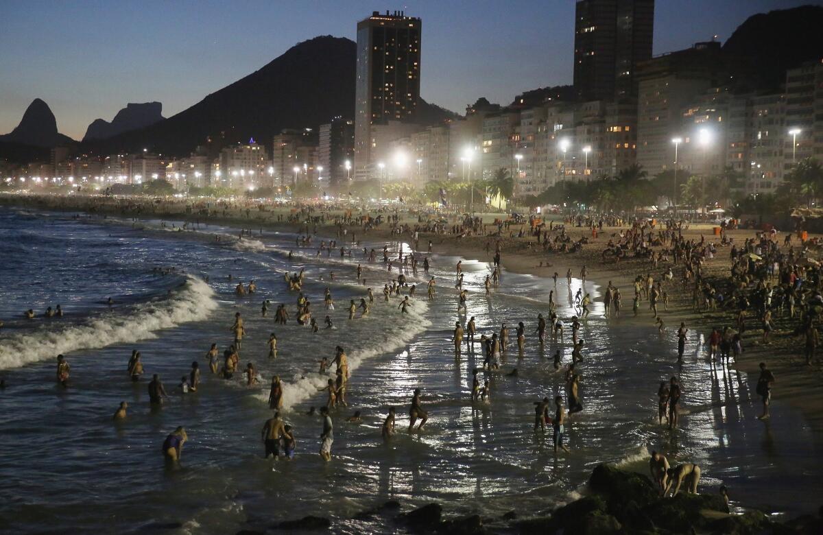 A summer heat wave sent residents of Rio de Janeiro to Copacabana beach as the sun set on Jan. 17. A new study says the planet's urban areas have been experiencing more heat waves and hotter nights over the past four decades.