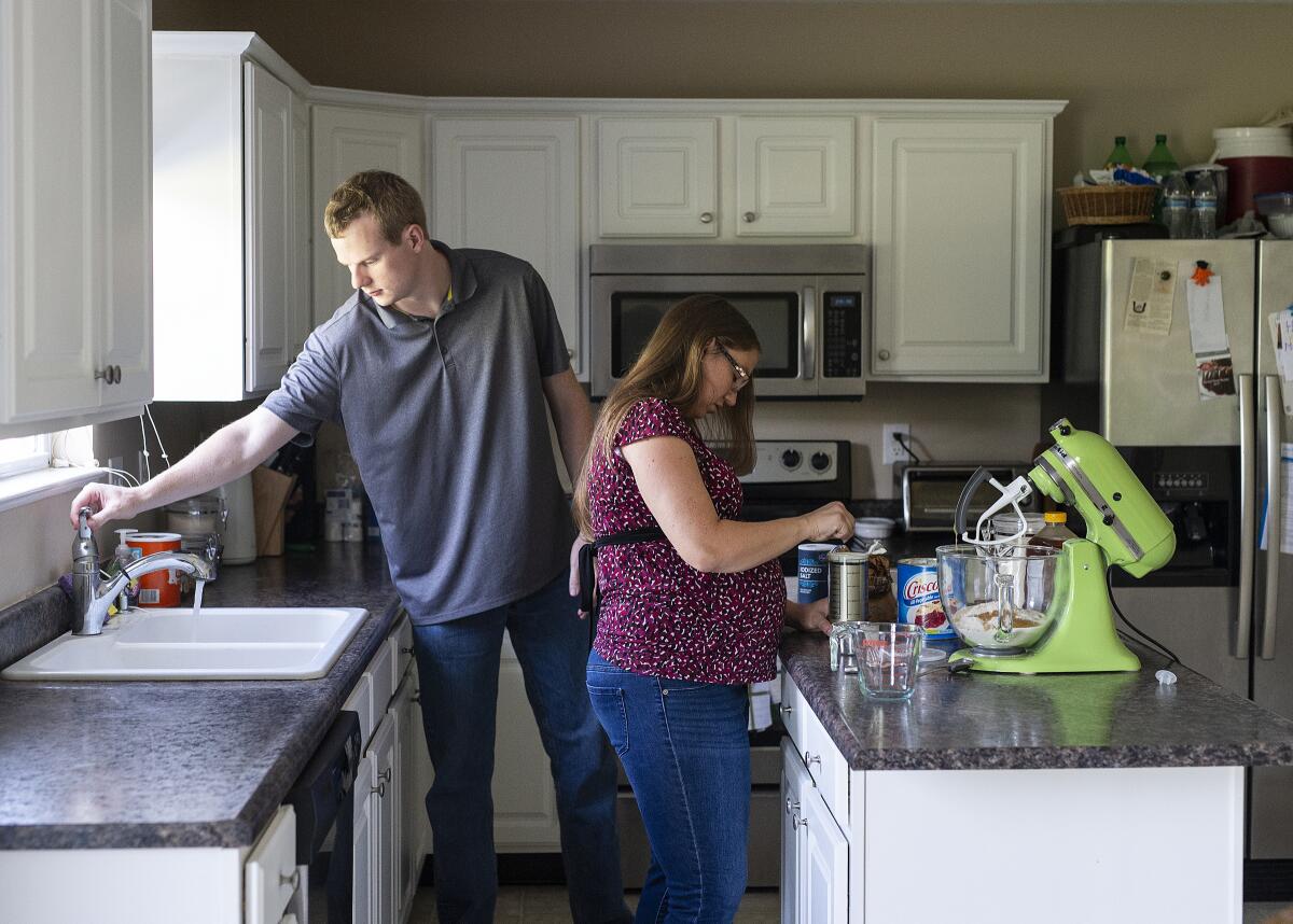 Rebecca Grimm makes homemade bread alongside her husband, Mark, at their home in Westfield, Ind., on Aug. 25. Grimm was pregnant with her second child in 2018 when she had a miscarriage. The couple were billed almost $6,000. 