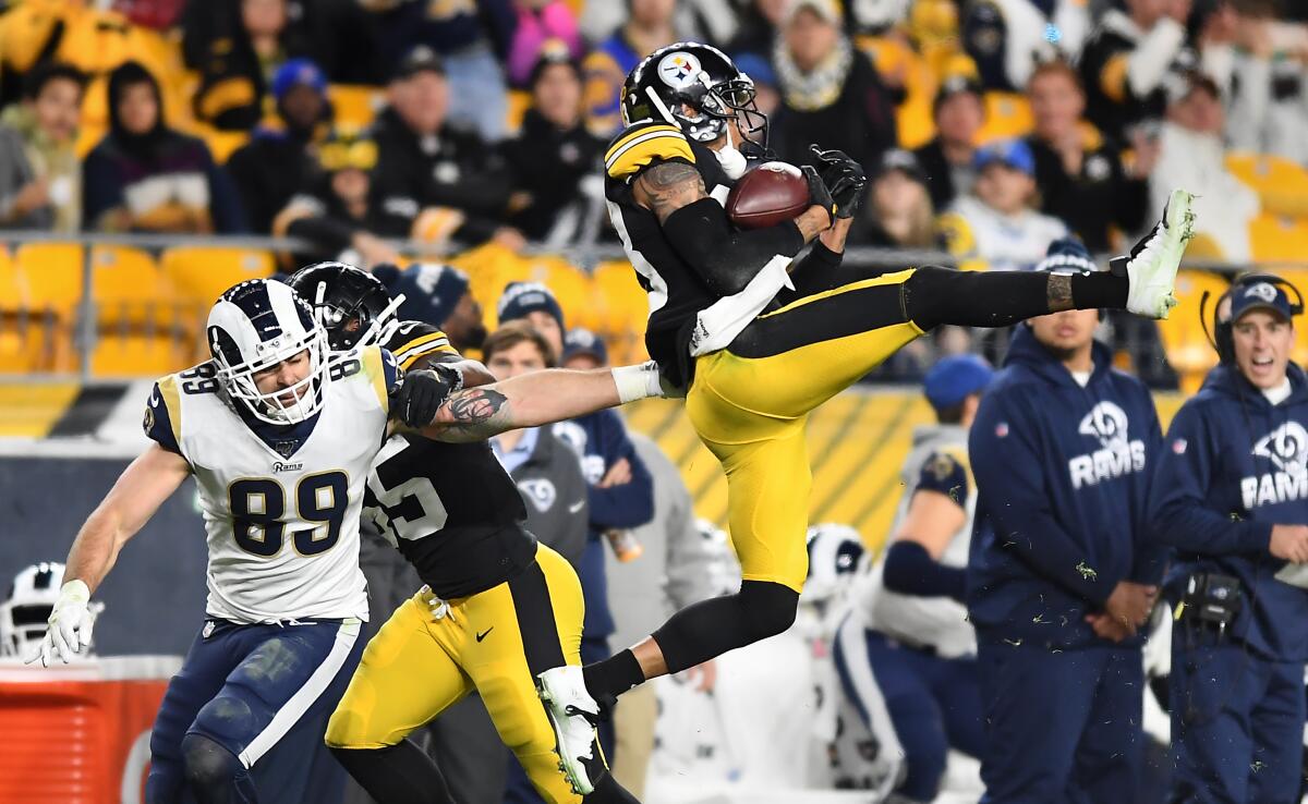 Steelers cornerback Joe Haden intercepts a pass intended for Rams tight end Tyler Higbee in the third quarter Sunday.