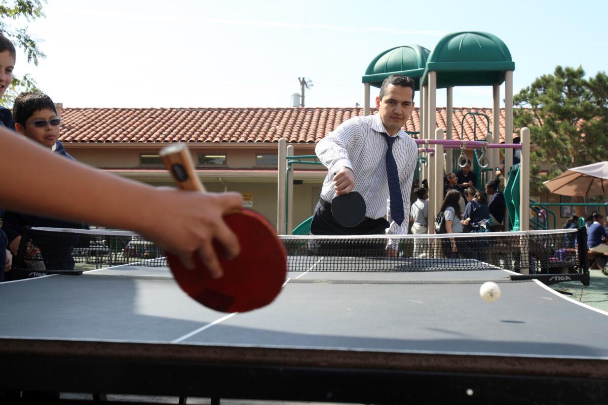 Principal John Terzi plays table tennis with students during recess at Magnolia Science Academy in Palms on March 3, 2014. The school is one of two Magnolia campuses that the L.A. Unified School District ordered shut down after an audit.