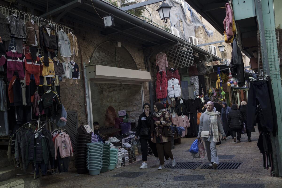 Muslim women walk through a market in the Old City of Jerusalem ahead of the holy Islamic month of Ramadan.