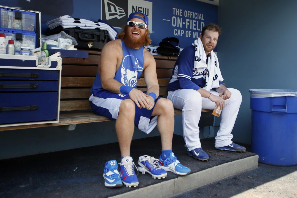 Justin Turner, left, laughs with Brett Anderson during practice on Tuesday.