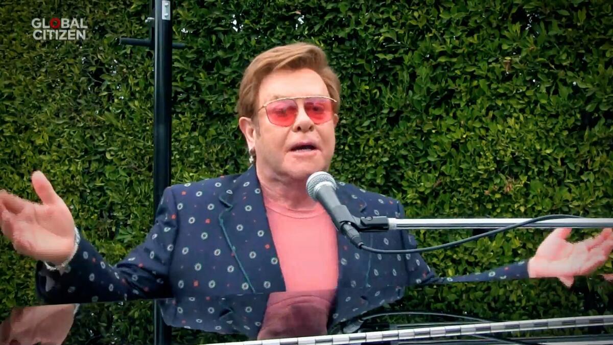 Elton John performs at a piano during the Global Citizen: Together at Home concert.