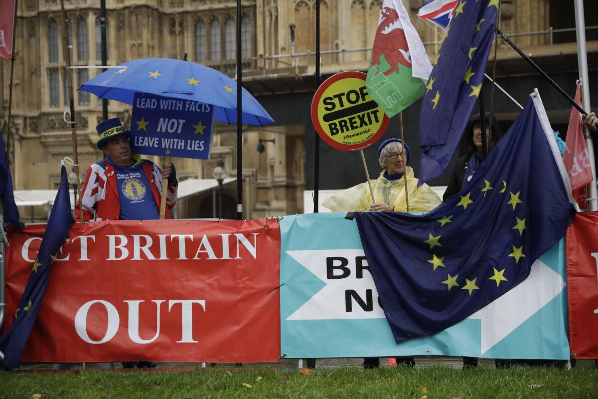 Supporters of Britain remaining in the European Union protest near banners placed by Brexit supporters Oct. 24 outside Parliament.