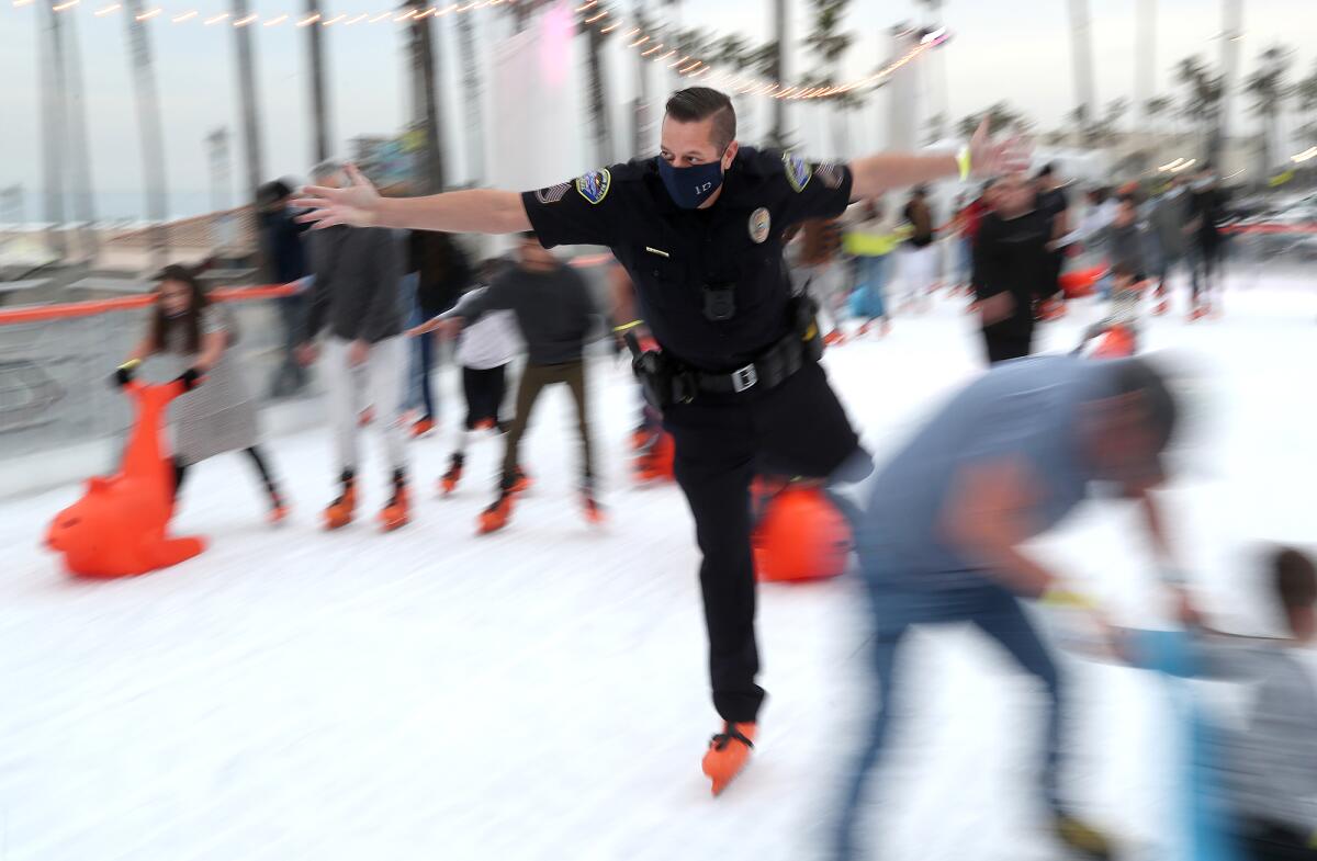 Sgt. Roman Altenbach of the Huntington Beach Police Department joins others on the ice during the "Skate With HBPD" event.