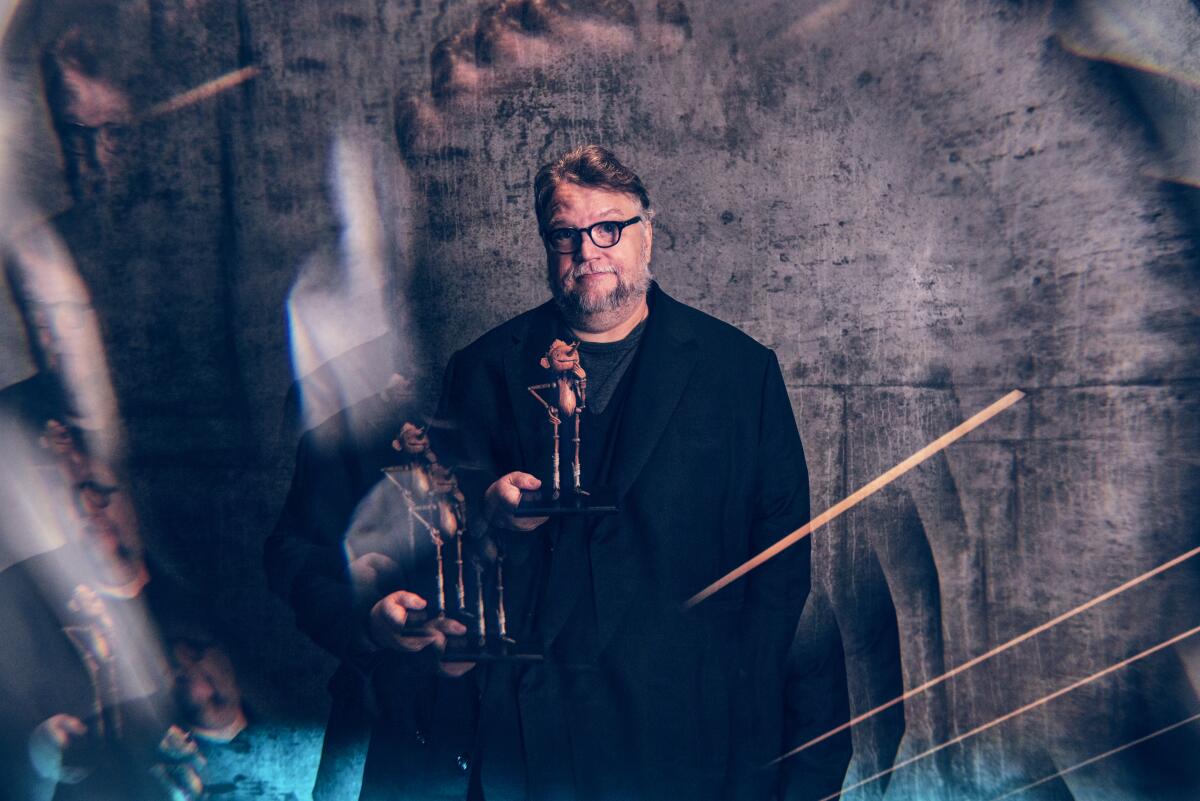 Guillermo del Toro poses with a Pinocchio puppet in a multiple exposure portrait.