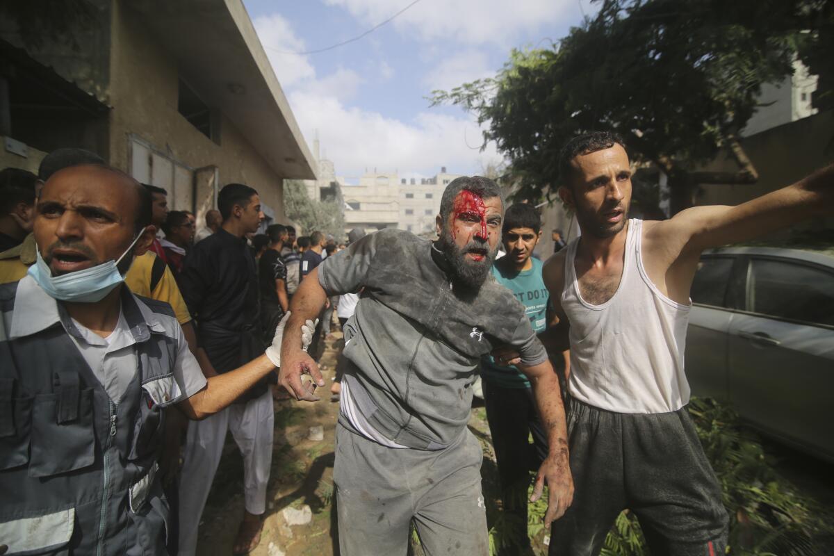 Palestinos son evacuados de edificios alcanzados por bombardeos israelíes sobre la Franja de Gaza
