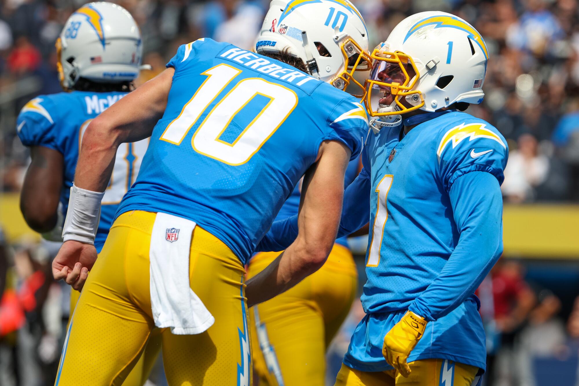 Chargers receiver DeAndre Carter celebrates with quarterback Justin Herbert after they connect for a touchdown.