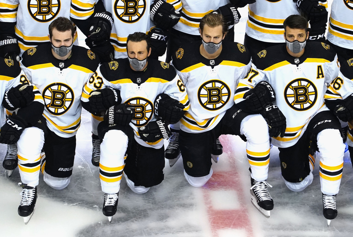 Boston Bruins players pose for a photo before an exhibition game at Rogers Place.