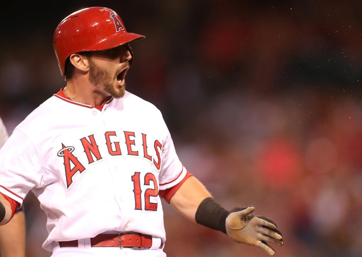 Angels second baseman Johnny Giavotella reacts after hitting a triple against the Mariners.