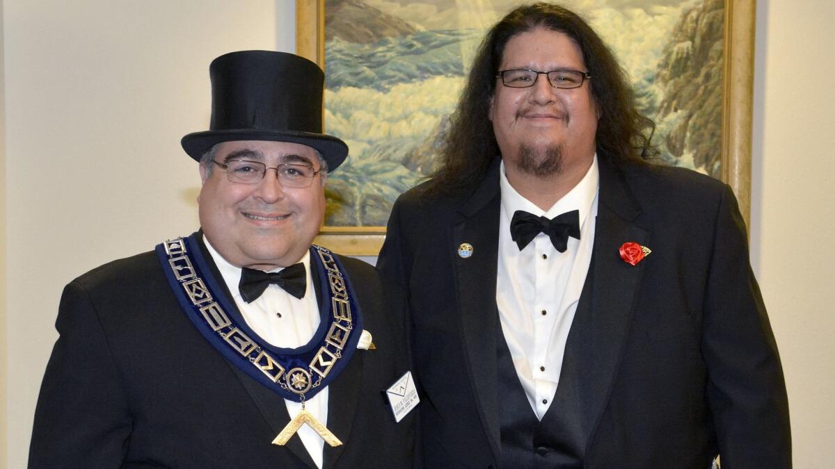 Outgoing Worshipful Master Jhairo Echevarria, right, passed the gavel of Lodge 406's leadership to his successor Jesus Valdiviezo at last week's installation ceremony.