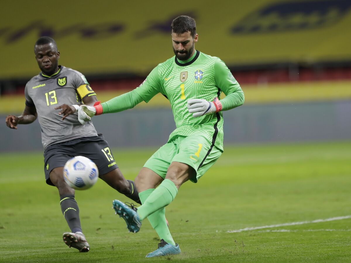 Brazil's goalkeeper Alisson, right, makes a save against Ecuador's Enner Valencia during a qualifying soccer match for the FIFA World Cup Qatar 2022 at Beira-Rio stadium in Porto Alegre, Brazil, Friday, June 4, 2021. (AP Photo/Andre Penner)