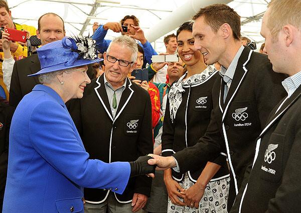 Queen Elizabeth II meets runner Nick Willis of New Zealand as she and the duke of Edinburgh, not pictured, tour the Olympic village.