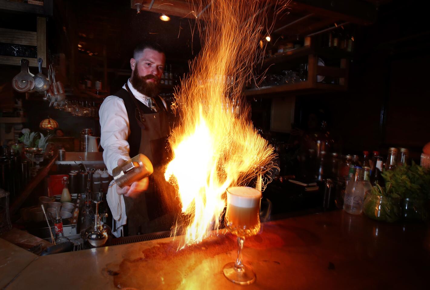 Andrew Winters, bartender at the Blind Rabbit speakeasy was concocting the "Wait for it" a flaming drink, at the Anaheim Packing House in Anaheim.