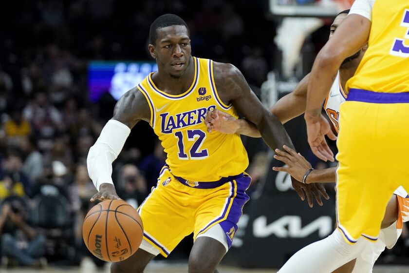 Los Angeles Lakers guard Kendrick Nunn dribbles the ball against the Phoenix Suns during the first half of a preseason NBA basketball game Wednesday, Oct. 6, 2021, in Phoenix.(AP Photo/Ross D. Franklin)