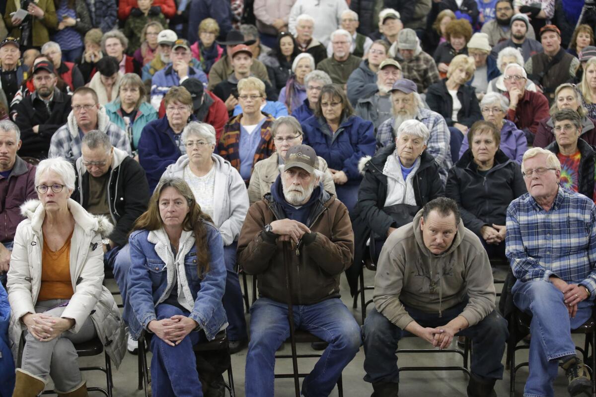 Residents look on as Sheriff David Ward address concerns at a community meeting at the Harney County Fairgrounds in Burns, Ore.
