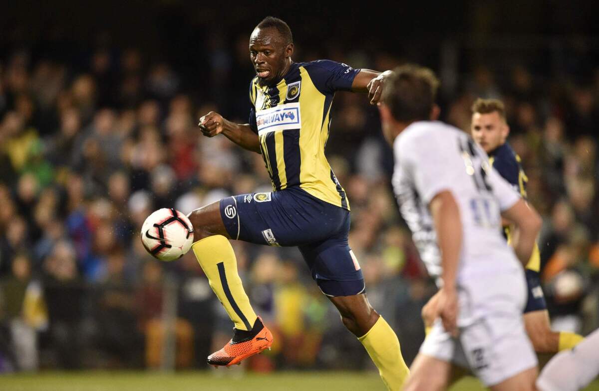 Olympic sprinter Usain Bolt (C), playing for A-League football club Central Coast Mariners, shoots on goal against Macarthur South West United in his first competitive start for the club in Sydney on October 12, 2018.