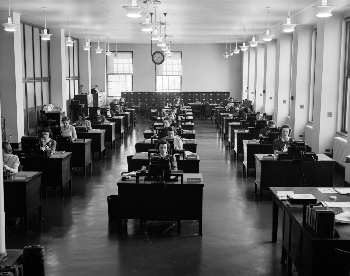 Rows of desks with secretaries working