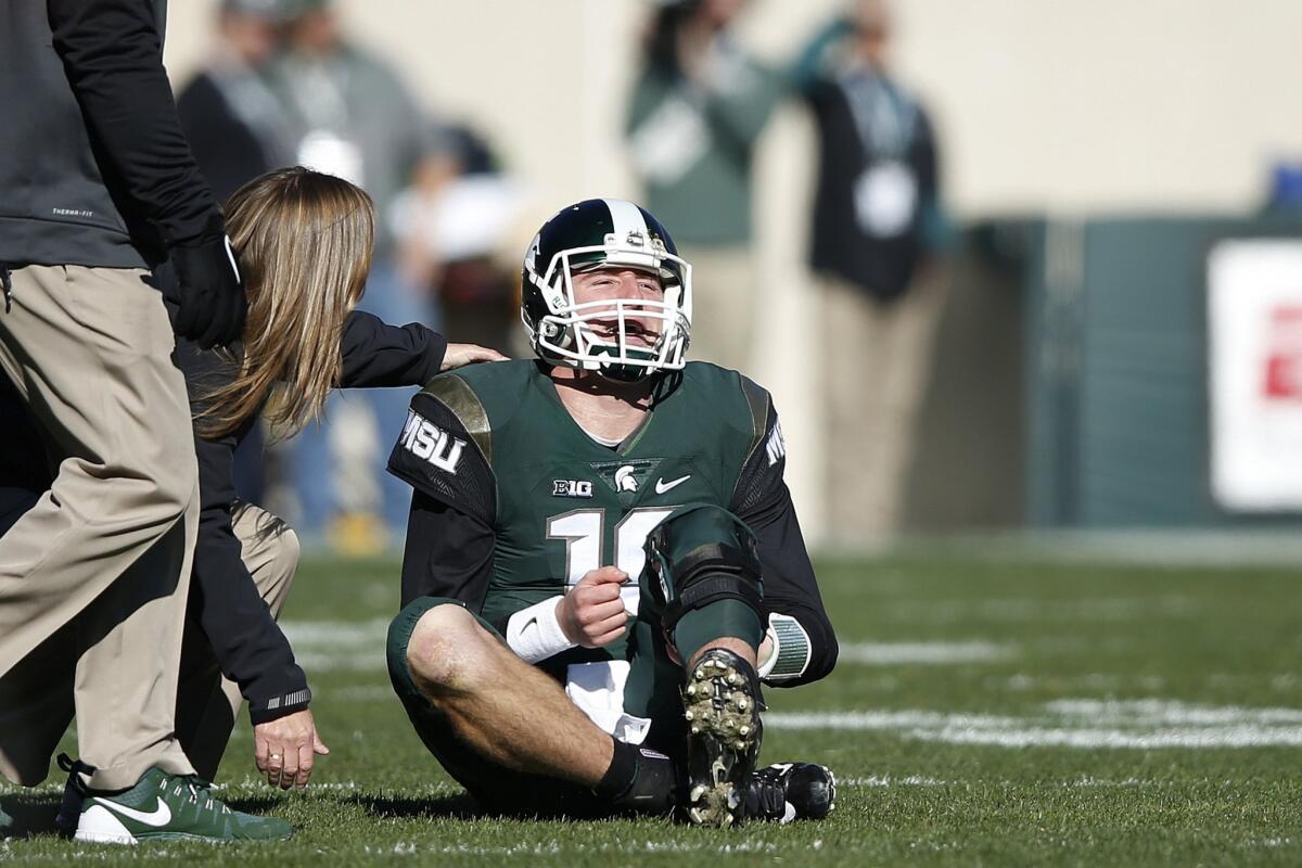 Michigan State quarterback Connor Cook sits on the field after being injured during the first half against Maryland.