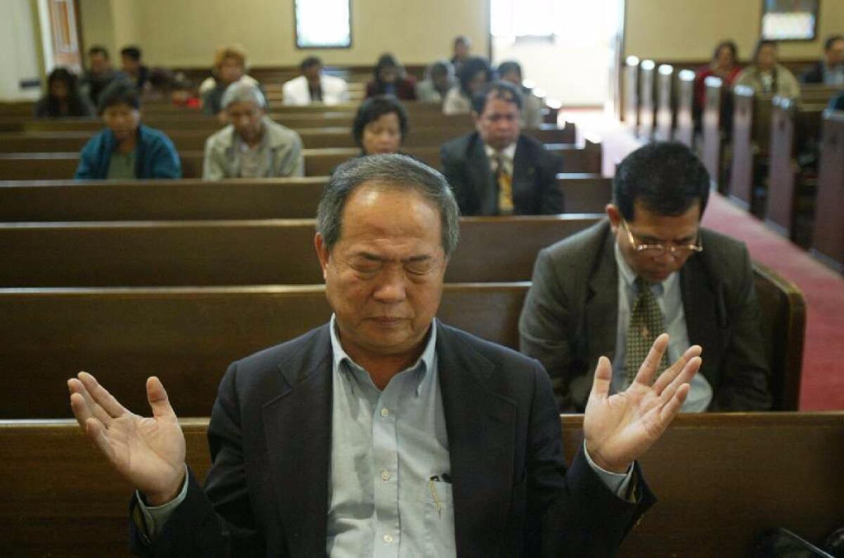 Ted Ngoy worships at the East Side Christian Church in Long Beach in November 2004. (Gary Friedman / Los Angeles Times)