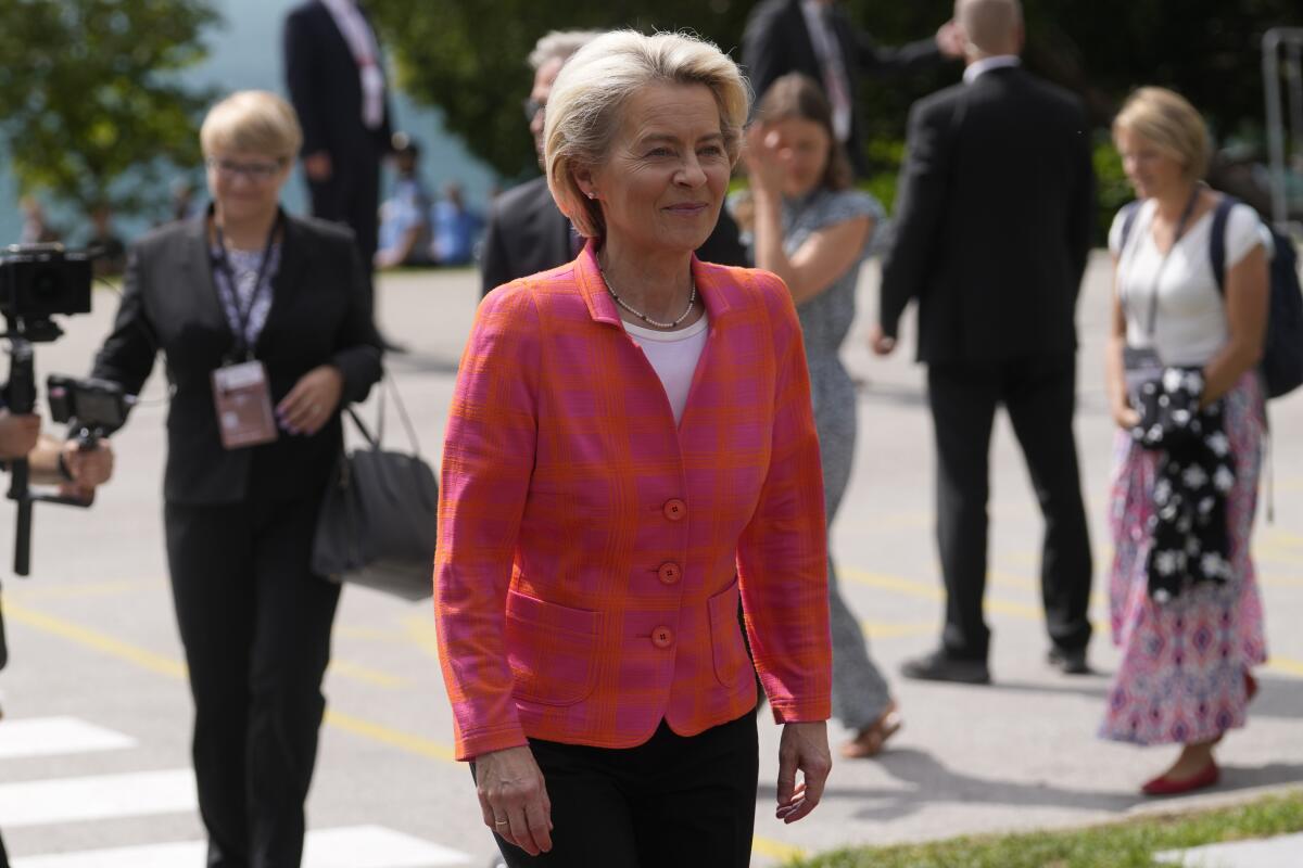 Ursula von der Leyen walks into a conference.