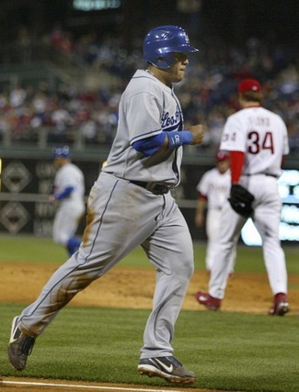 Los Angeles Dodgers' Dioner Navarro heads for home plate from third base after Philadelphia Phillies pitcher Gavin Floyd (34) walked-in a run in the second inning.