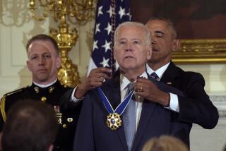 President Barack Obama presents Vice President Joe Biden with the Presidential Medal of Freedom during a ceremony in the State Dining Room of the White House in Washington, Jan. 12, 2017. (AP Photo/Susan Walsh)