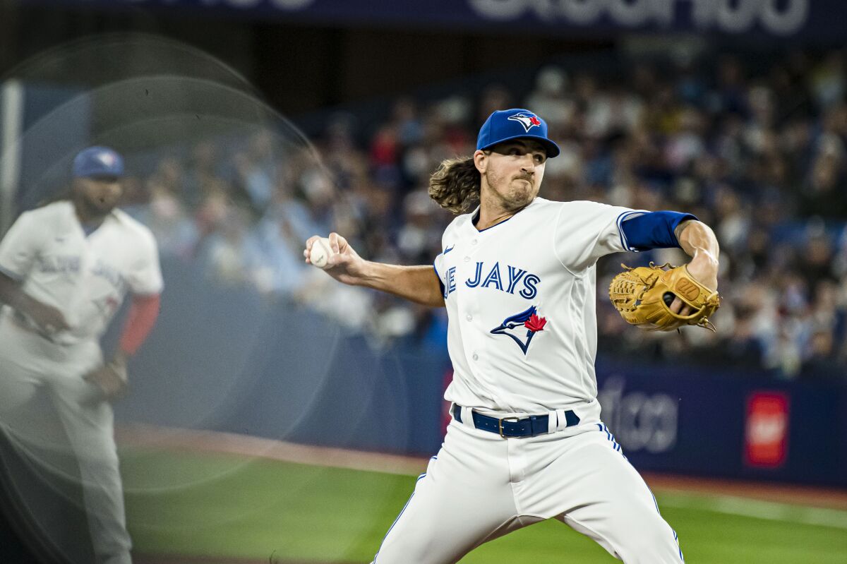 Toronto Blue Jays starting pitcher Kevin Gausman (34) throws a pitch during the first inning of a baseball game against the Texas Rangers, Saturday, April 9, 2022, in Toronto. (Christopher Katsarov/The Canadian Press via AP)