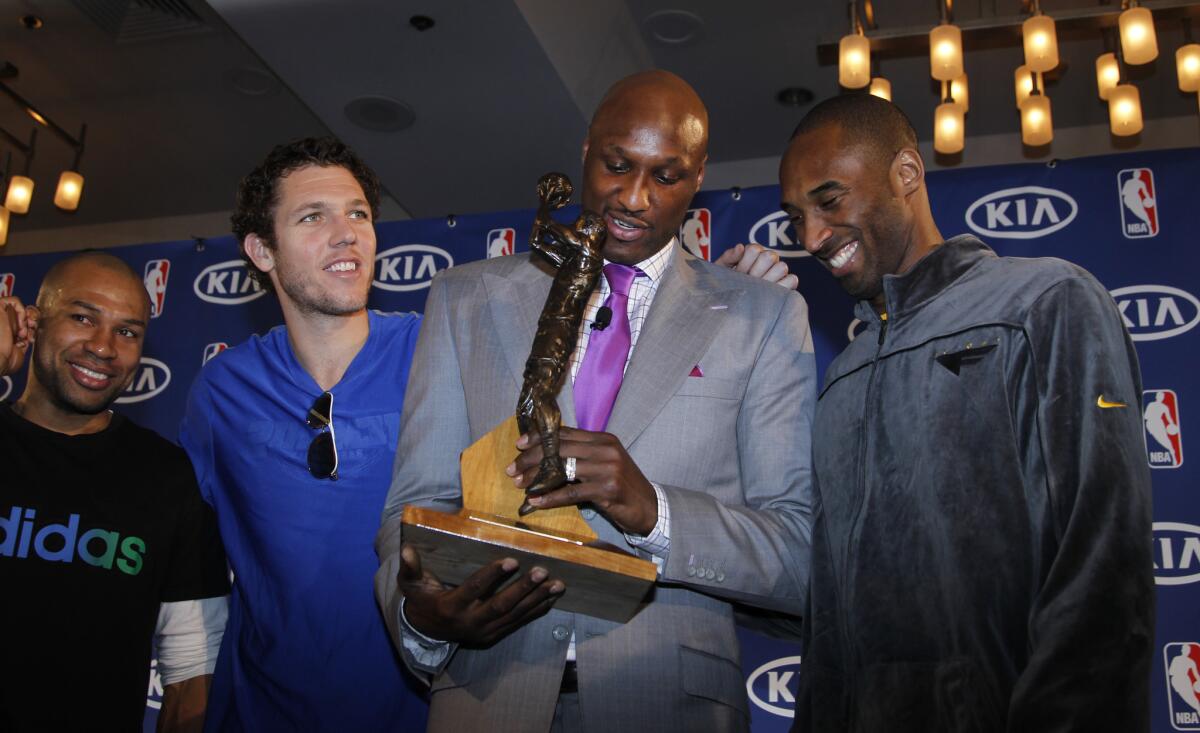 Lamar Odom, a forward for the Los Angeles Lakers, received the Sixth Man Award on April 19, 2011 at the Sheraton Gateway Hotel in Los Angeles with teammates Derek Fisher, Luke Walton and Kobe Bryant.