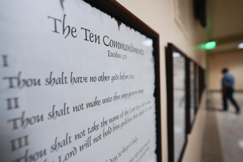 FILE - A copy of the Ten Commandments is posted along with other historical documents in a hallway of the Georgia Capitol, Thursday, June 20, 2024, in Atlanta. Civil liberties groups filed a lawsuit Monday, June 24, challenging Louisiana’s new law that requires the Ten Commandments to be displayed in every public school classroom. (AP Photo/John Bazemore, File)