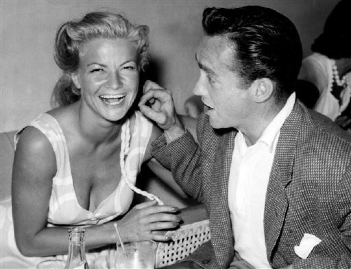 FILE - In this August 29, 1955 file photo Irish actor Richard Todd, right, jokes with French actress Anne Marie Marsen in Venice, Italy. The actor's family announced Friday, Dec. 4, 2009, that the actor had died of cancer at the age 90 on Thursday. Todd drew on his wartime exploits as a British army paratrooper in the 1962 film "The Longest Day" and was nominated for an Academy Award for the 1949 film "A Hasty Heart" as well as starring in one of his best-known roles playing Royal Air Force pilot Guy Gibson in "The Dam Busters." (AP Photo/Str)