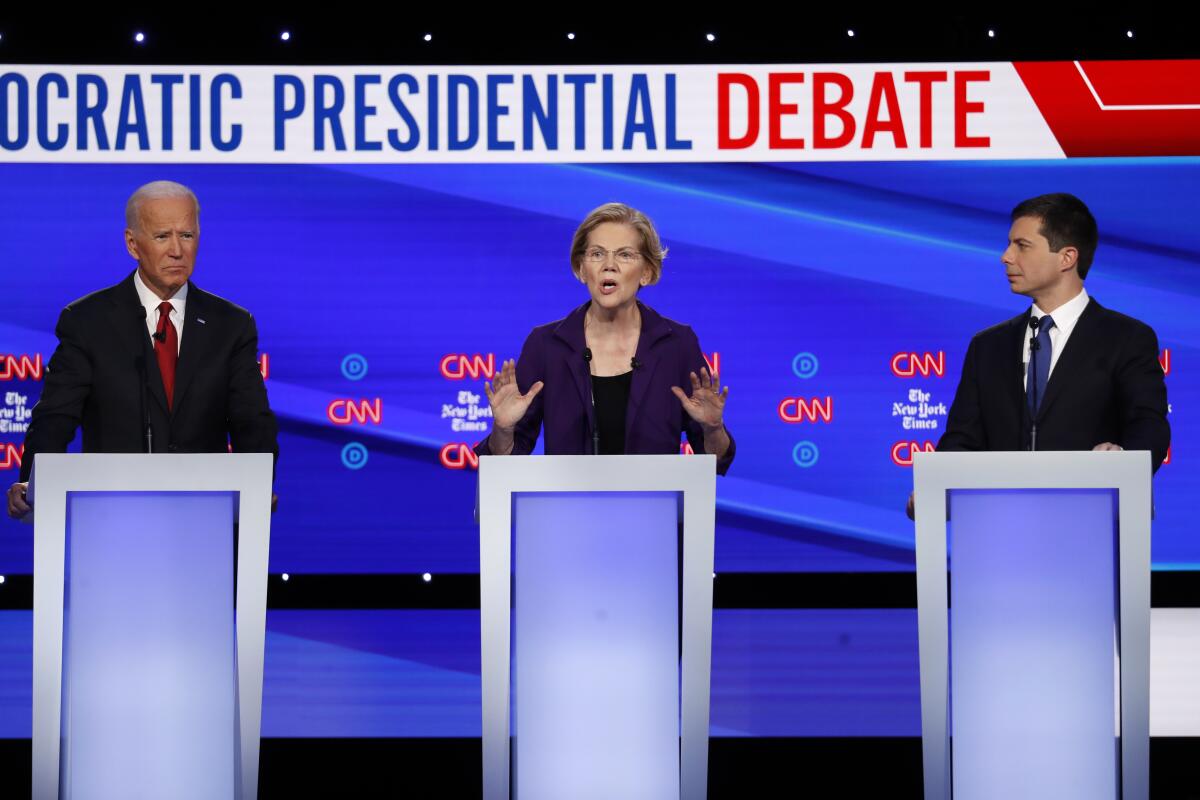 Democratic presidential candidates Joe Biden, Elizabeth Warren and Pete Buttigieg at the Oct. 15 primary debate at Otterbein University in Westerville, Ohio.