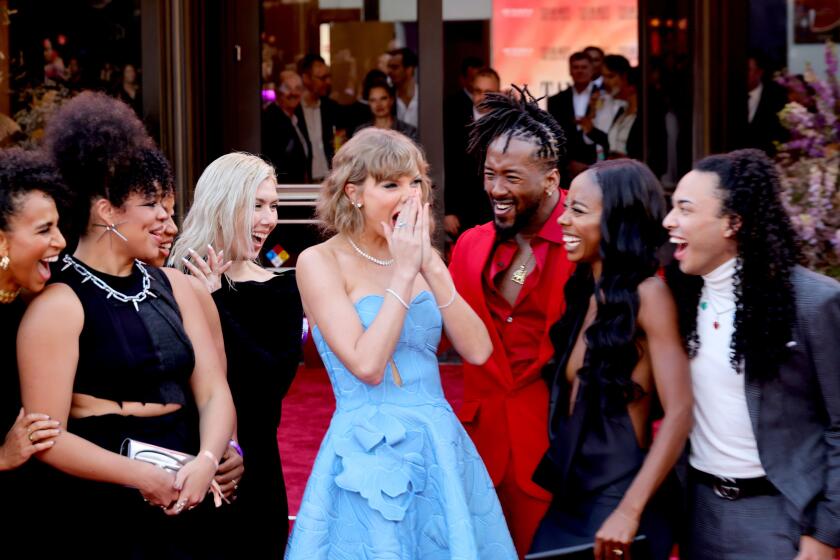 LOS ANGELES, CALIFORNIA - OCTOBER 11: Taylor Swift (C) with dancers and crew attend "Taylor Swift: The Eras Tour" Concert Movie World Premiere at AMC The Grove 14 on October 11, 2023 in Los Angeles, California. (Photo by Matt Winkelmeyer/Getty Images)