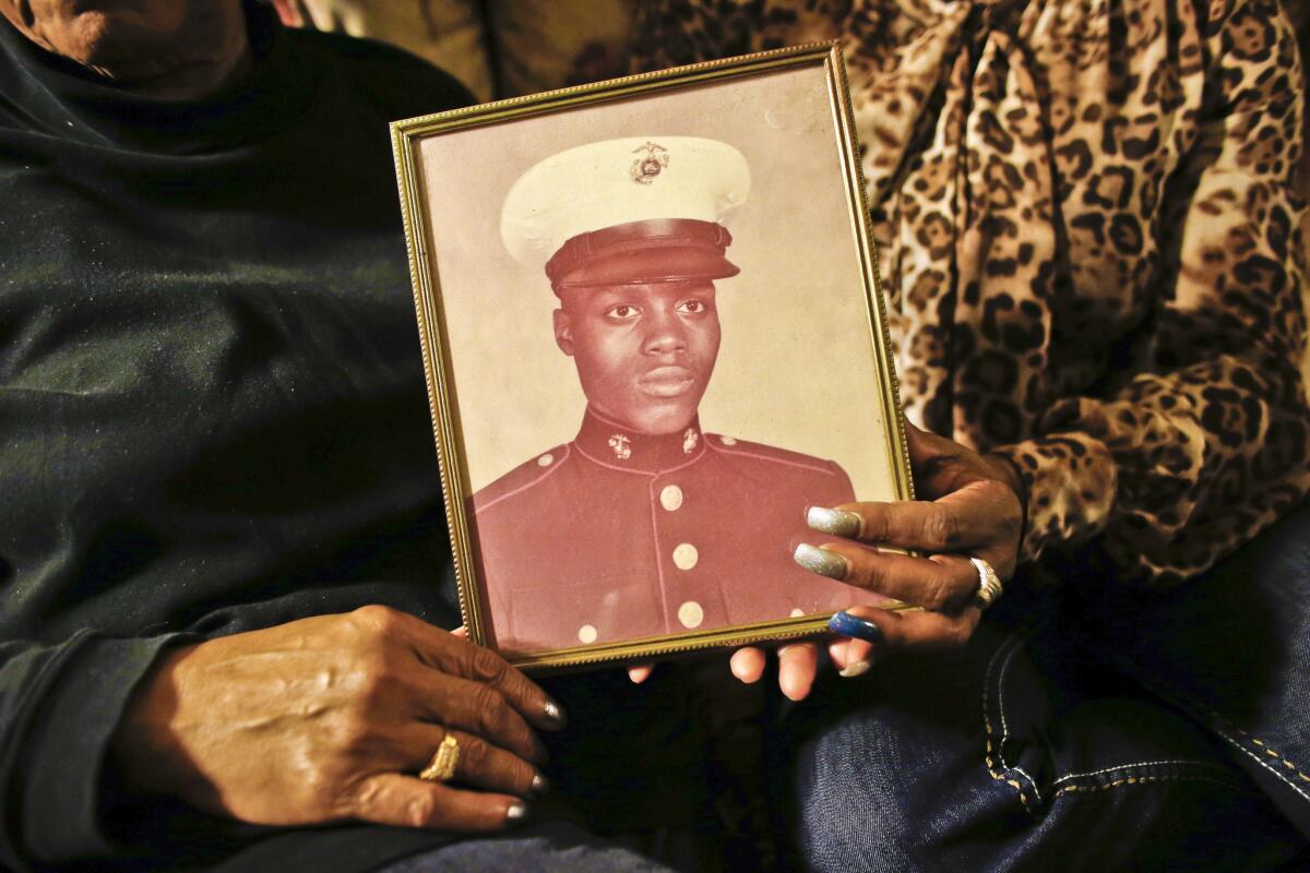 A picture of Jerome Murdough is held by his mother, Alma Murdough, left, and sister, Cheryl Warner, at Alma Murdough's home in Queens, N.Y., on March 12.