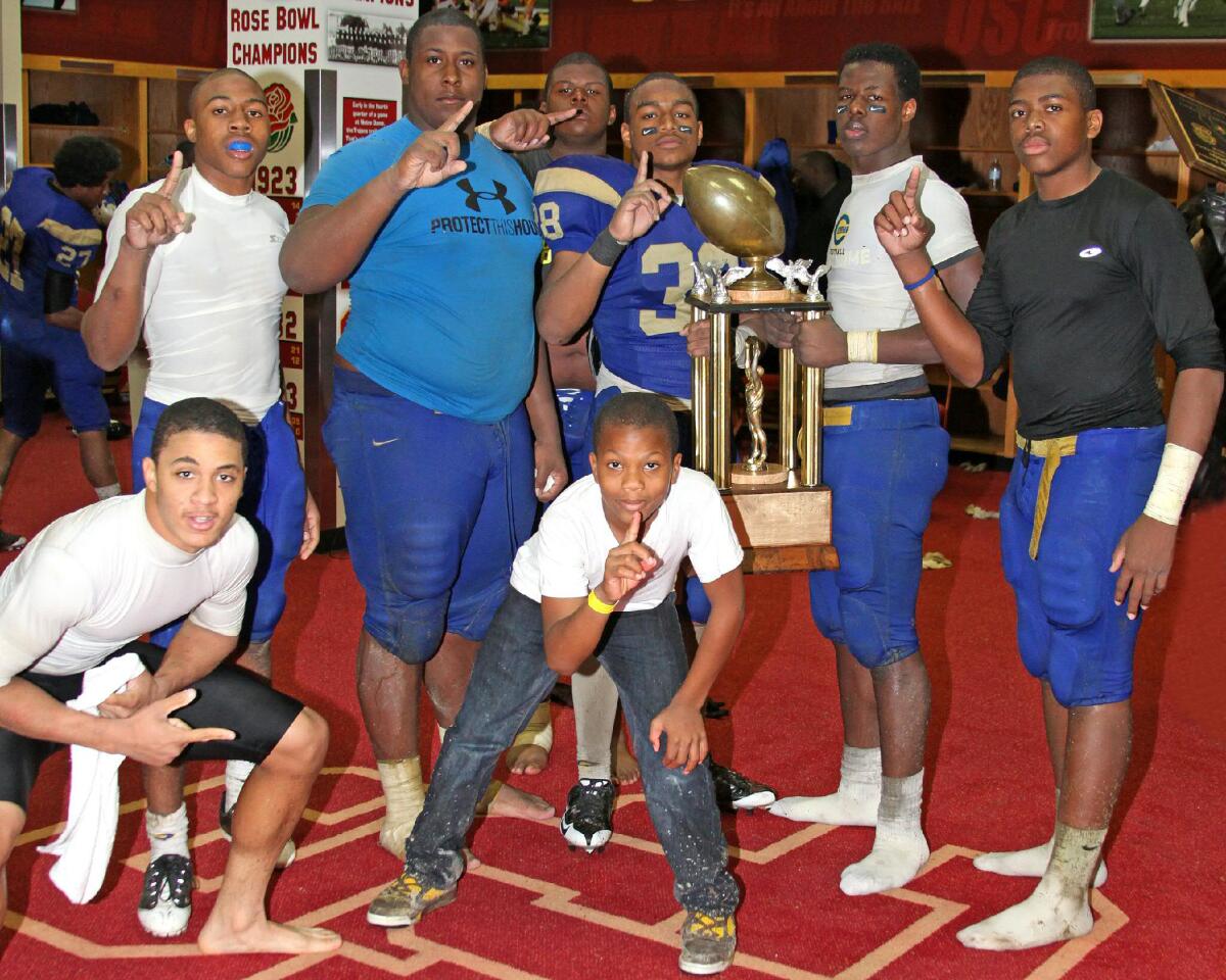 Daiyan Henley (middle) when he was a ball boy for Crenshaw High posing in USC locker room in 2009.
