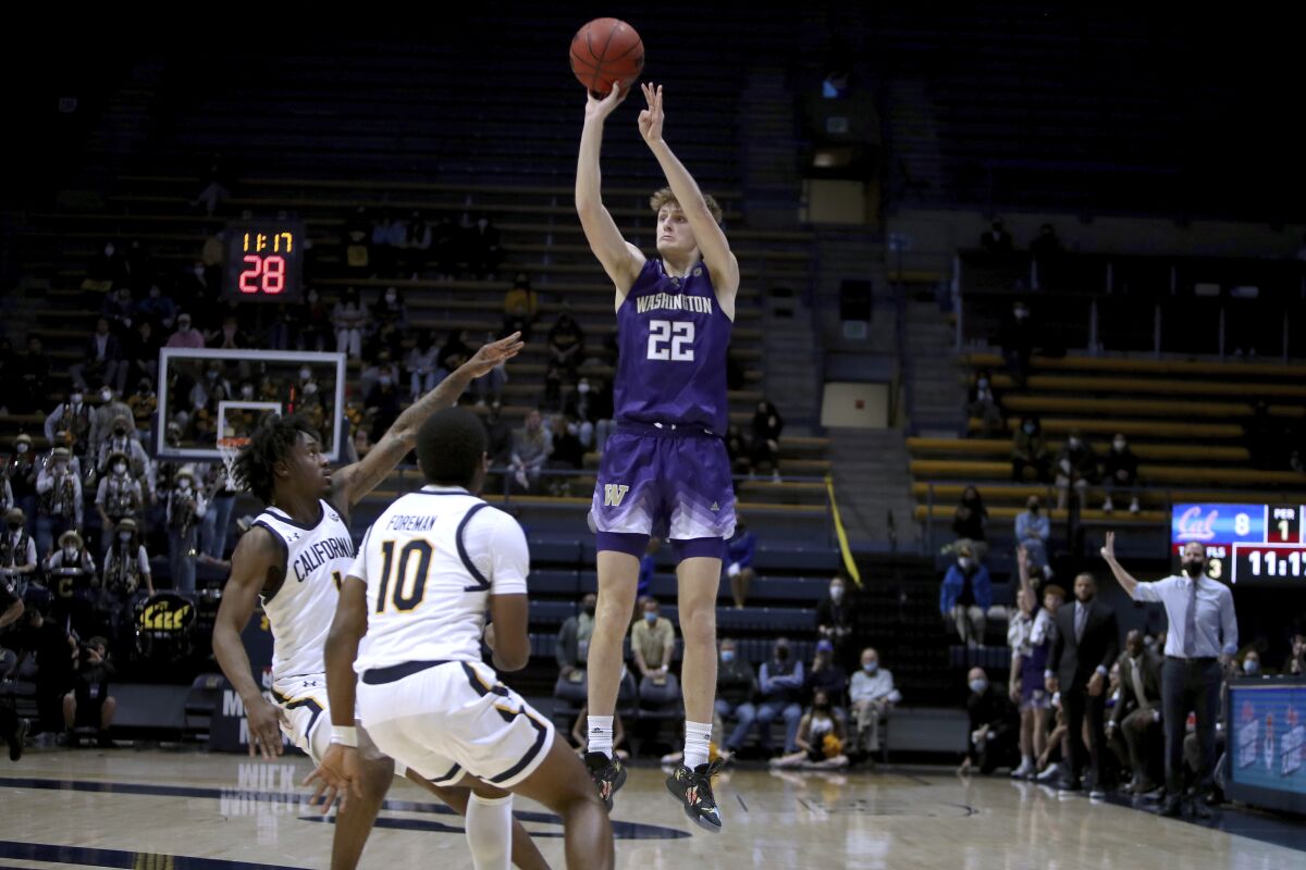 Washington guard Cole Bajema (22) shoots over California guard Joel Brown (1) and guard Makale Foreman (10) during the first half of an NCAA college basketball game Thursday, Feb. 3, 2022, in Berkeley, Calif. (AP Photo/Scot Tucker)