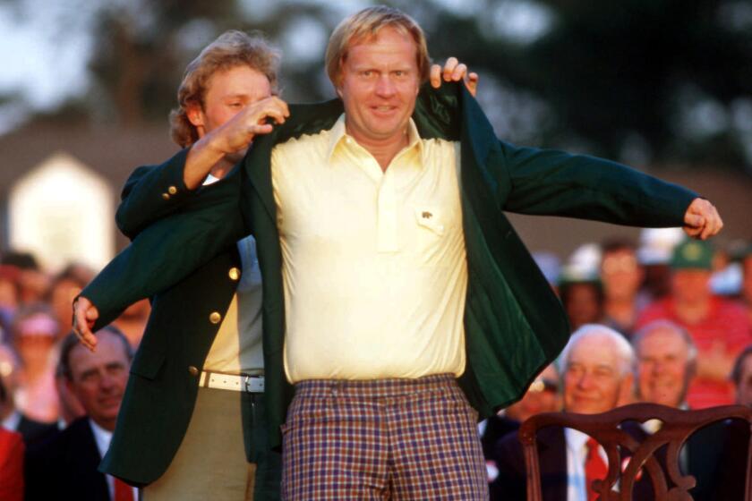Jack Nicklaus slips on the winner's green jacket at the Masters in 1986.