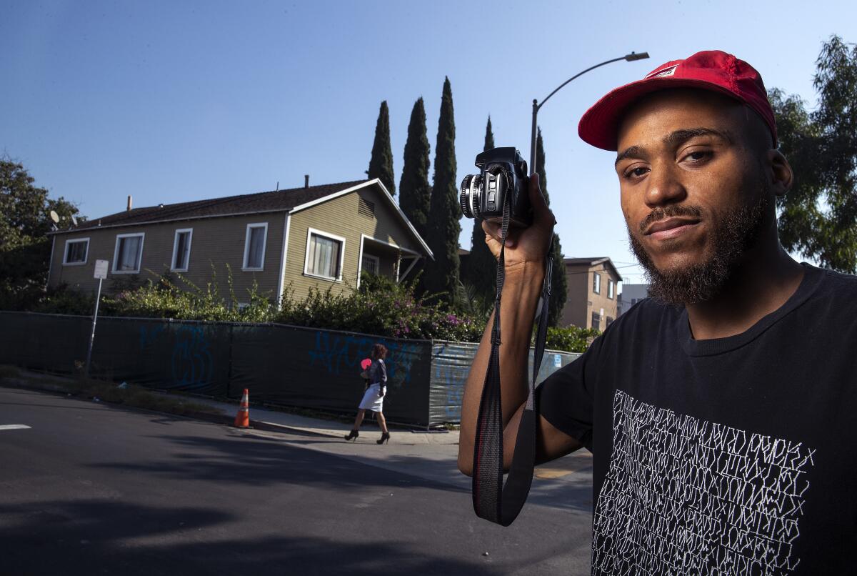 Photojournalist Lexis-Olivier Ray on Nov. 6 with an L.A. Craftsman-style building slated for demolition.