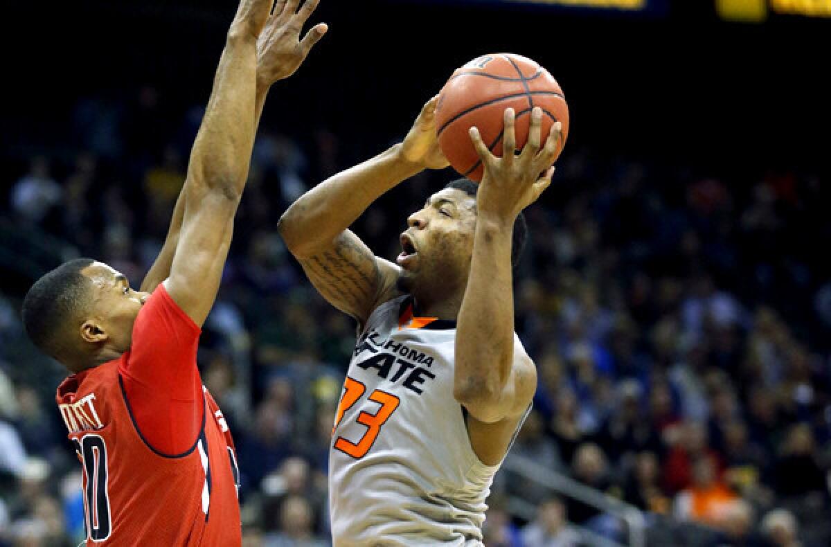 Oklahoma State guard Marcus Smart (33) elevates for a shot over Texas Tech forward Jaye Crockett in the second half of their Big 12 Conference tournament game on Wednesday.