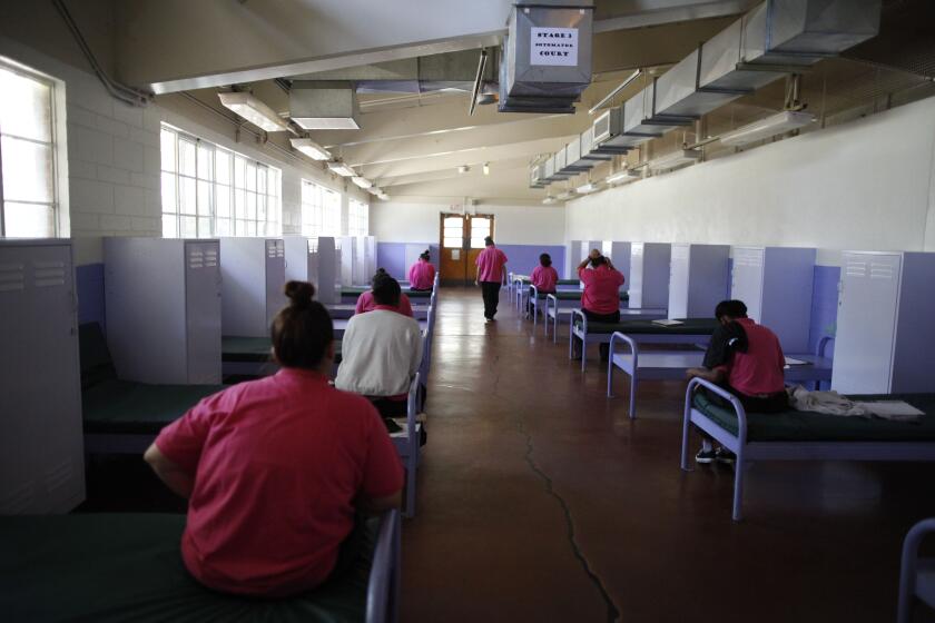 LOS ANGELES-- September 27, 2015 - Camp Scott youth sit at attention on their beds and wait for movement instructions during lunch break. Youths are asked by Probation Officers to sit in uniform in an attempt to keep them focused.