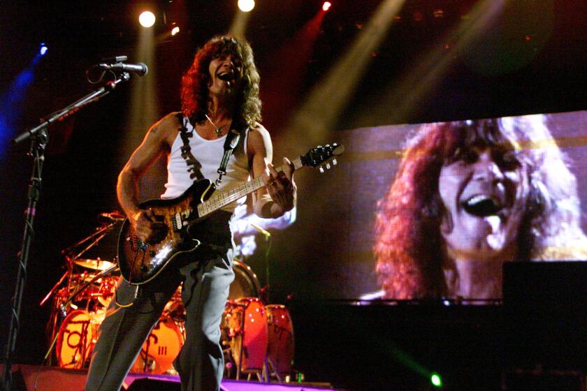 CA.Van Halen.3.0704.RG ññ Eddie Van Halen leads his band bearing his last name during a Fourth of July performance at the Blockbuster Pavillion in Devore, Saturday.