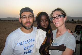 Gabriel Stauring and Katie-Jay Scott hold Darfuri refugee Guisma in Eastern Chad in 2009