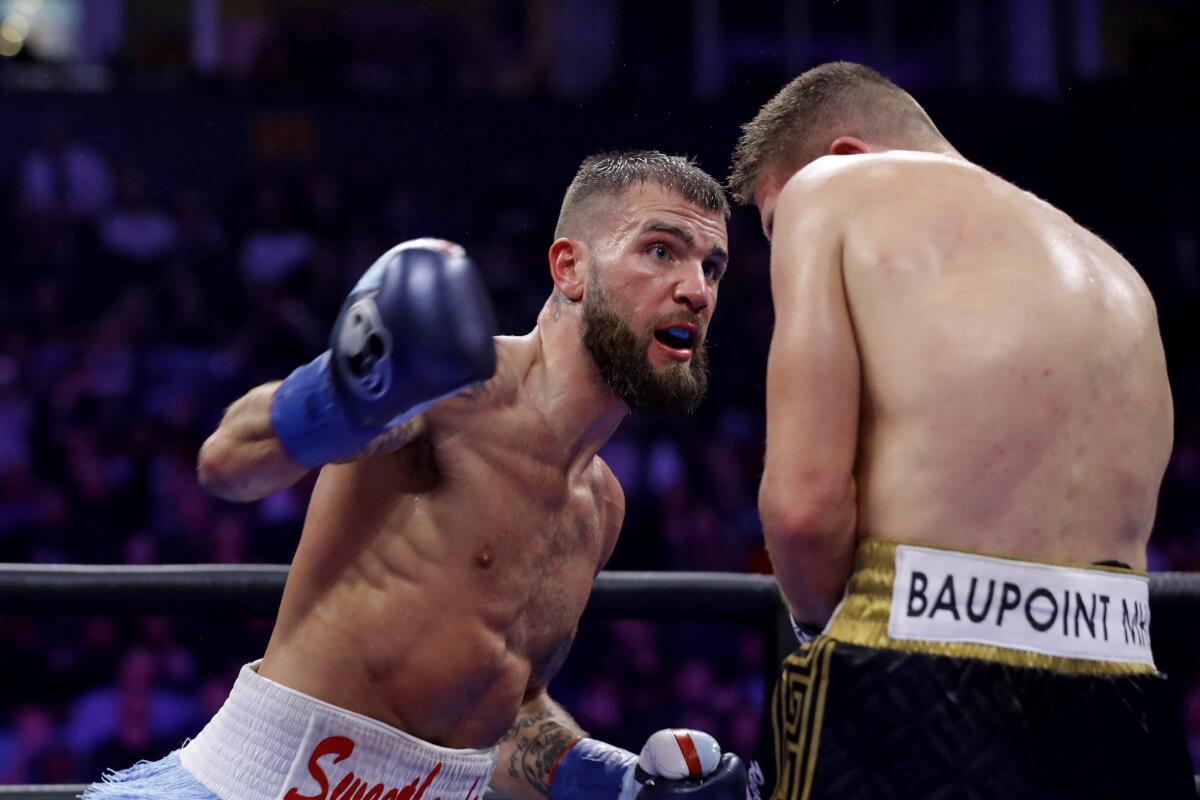 Caleb Plant swings at Vincent Feigenbutz during an IBF super middleweight championship match on Feb. 15, 2020