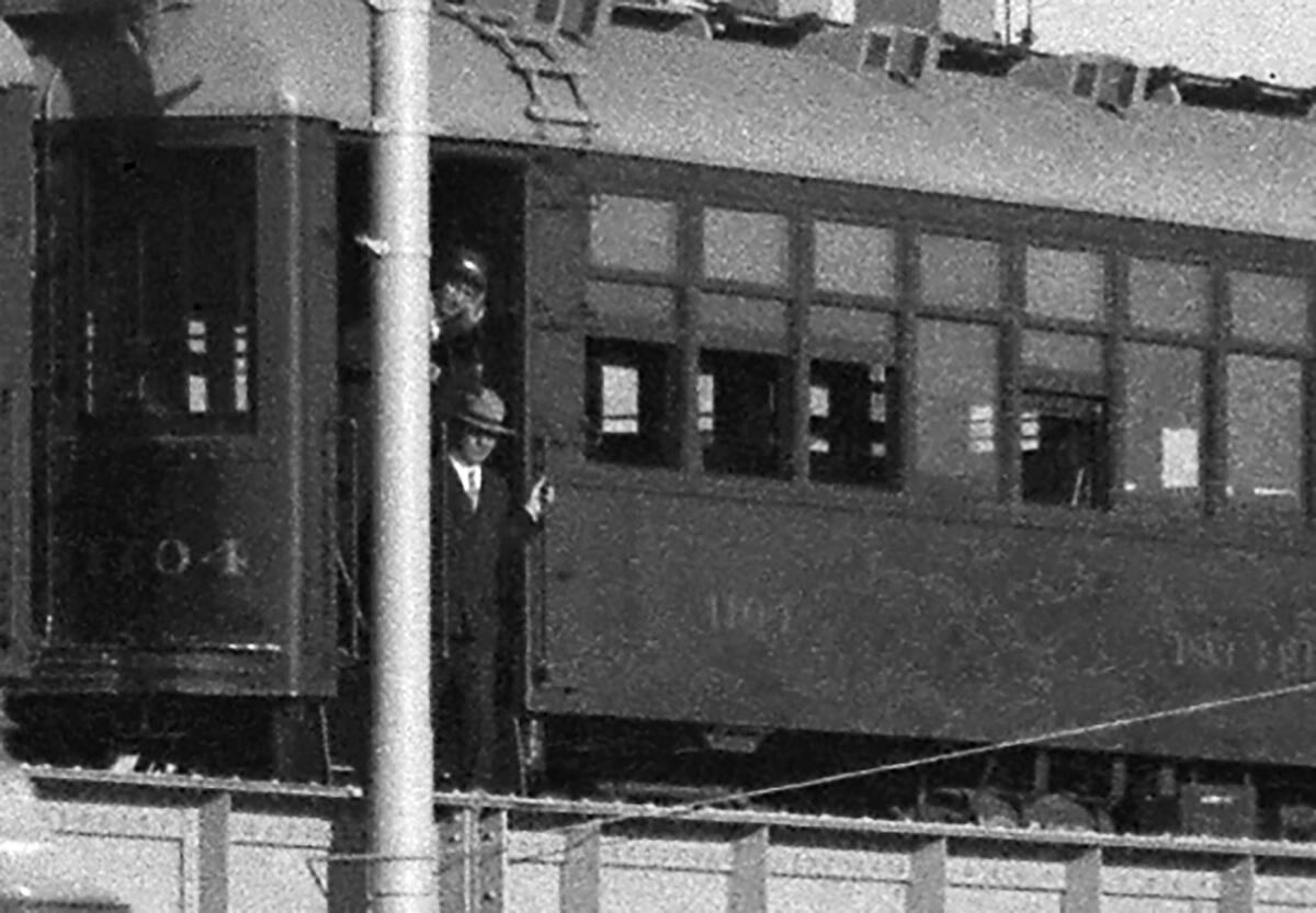Man exits Pacific Electric Red Car train sitting on new viaduct in 1927