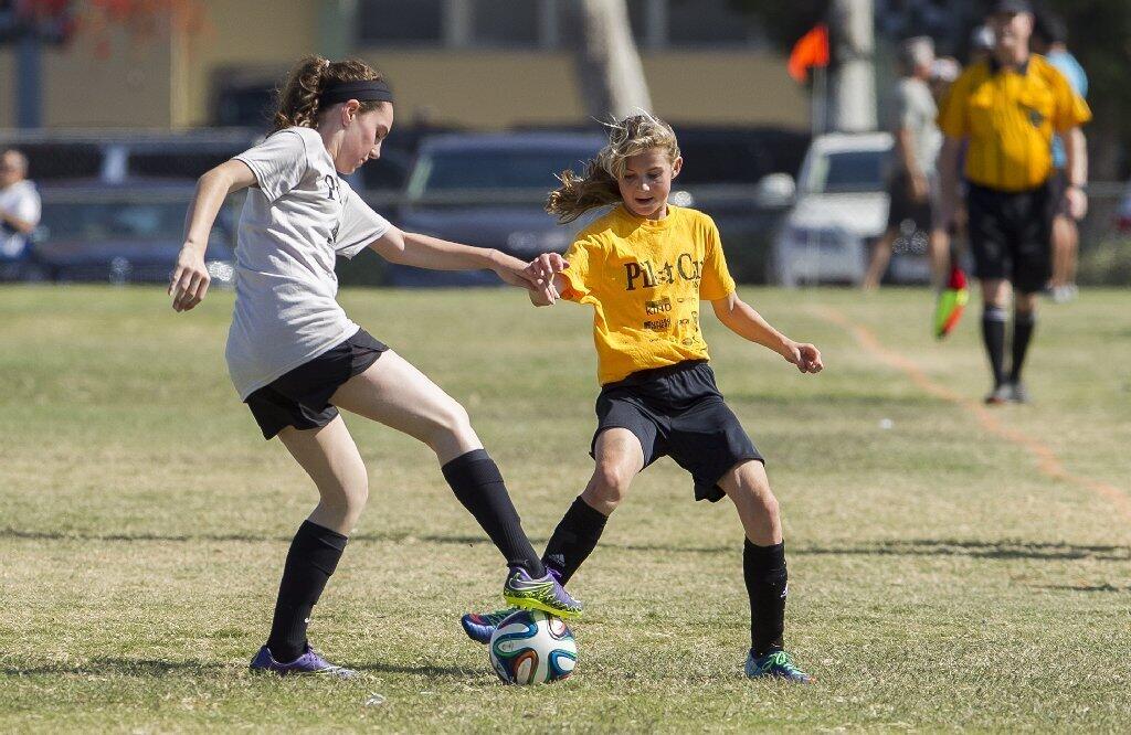 Harbor Day's Madeleine Luer challenges Pegasus' Emily Allison for control of the ball during a girls' 5-6 Gold Division game on Thursday.