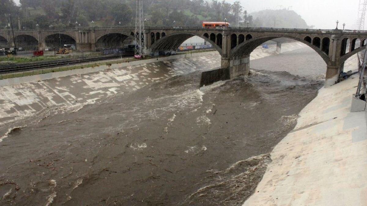 Stormwater flows down the mostly concrete-lined Los Angeles River near downtown on Feb. 2.